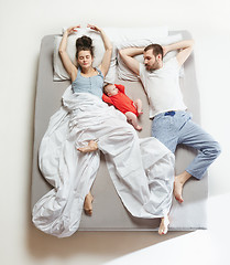 Image showing Top view of happy family with one newborn child in bedroom.