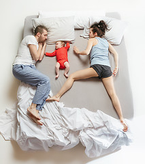 Image showing Top view of happy family with one newborn child in bedroom.