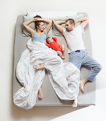 Image showing Top view of happy family with one newborn child in bedroom.