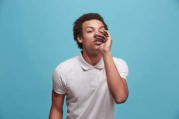 Image showing Isolated on blue young casual man shouting at studio