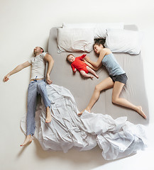 Image showing Top view of happy family with one newborn child in bedroom.