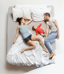 Image showing Top view of happy family with one newborn child in bedroom.