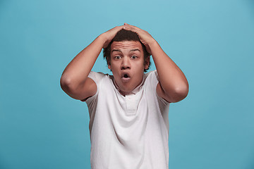 Image showing The young attractive man looking suprised isolated on pink