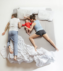 Image showing Top view of happy family with one newborn child in bedroom.