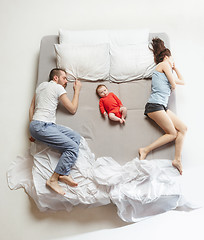 Image showing Top view of happy family with one newborn child in bedroom.