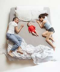 Image showing Top view of happy family with one newborn child in bedroom.