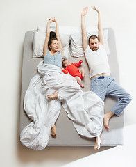 Image showing Top view of happy family with one newborn child in bedroom.