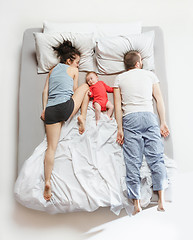 Image showing Top view of happy family with one newborn child in bedroom.