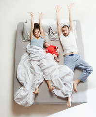 Image showing Top view of happy family with one newborn child in bedroom.