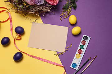 Image showing Easter card. Painted Easter eggs in nest on yellow background