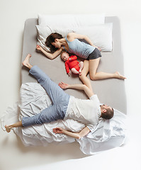 Image showing Top view of happy family with one newborn child in bedroom.