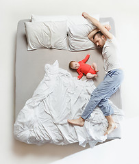 Image showing Top view of happy family with one newborn child in bedroom.