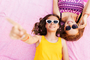 Image showing teenage girls in sunglasses on picnic blanket