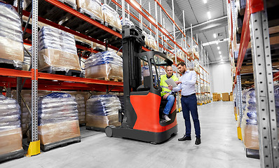 Image showing worker and businessman with tablet pc at warehouse