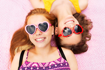 Image showing teenage girls in sunglasses on picnic blanket