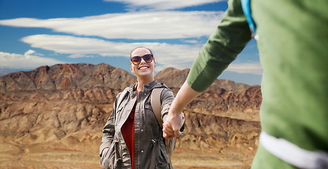 Image showing happy couple with backpacks hiking outdoors