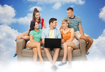 Image showing friends with laptop computer sitting on sofa