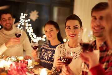 Image showing happy friends celebrating christmas at home