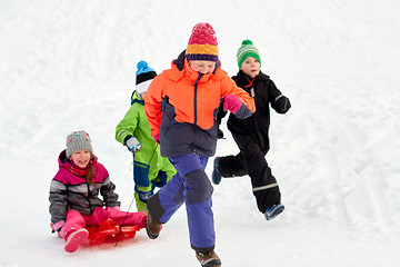 Image showing happy kids with sled having fun outdoors in winter