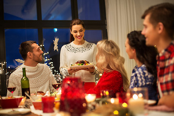 Image showing happy friends having christmas dinner at home