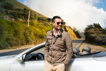 Image showing man at convertible car over big sur hills