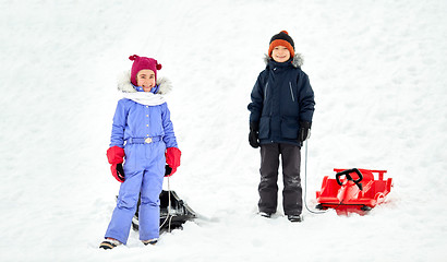 Image showing happy little kids with sleds in winter