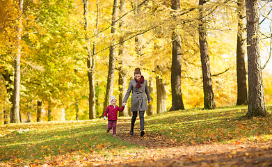 Image showing happy mother and little daughter at autumn park