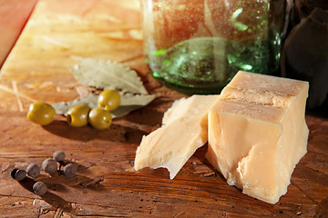 Image showing parmesan and olives on wooden surface 