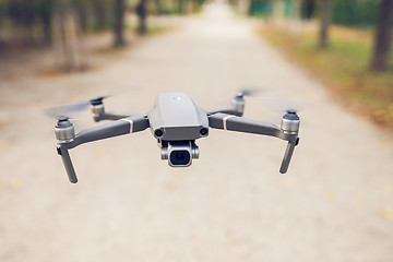 Image showing Drone flying in the air in the park alley