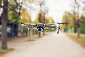 Image showing Drone flying in the air in the park alley