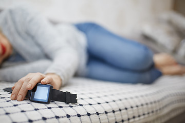 Image showing Woman sleeping with smartwatch 