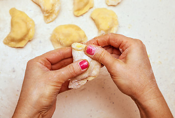 Image showing hands of chef who prepares ravioli 