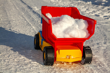 Image showing toy stuck with snow on road