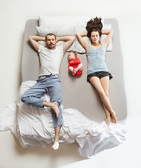 Image showing Top view of happy family with one newborn child in bedroom.