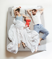 Image showing Top view of happy family with one newborn child in bedroom.