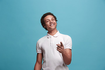 Image showing The happy business man point you and want you, half length closeup portrait on blue background.