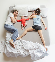 Image showing Top view of happy family with one newborn child in bedroom.