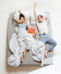 Image showing Top view of happy family with one newborn child in bedroom.