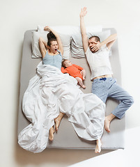 Image showing Top view of happy family with one newborn child in bedroom.