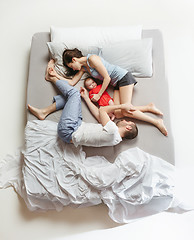 Image showing Top view of happy family with one newborn child in bedroom.