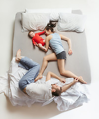 Image showing Top view of happy family with one newborn child in bedroom.