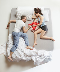 Image showing Top view of happy family with one newborn child in bedroom.