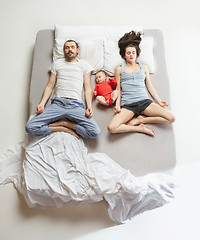 Image showing Top view of happy family with one newborn child in bedroom.