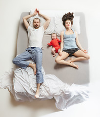 Image showing Top view of happy family with one newborn child in bedroom.