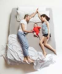 Image showing Top view of happy family with one newborn child in bedroom.