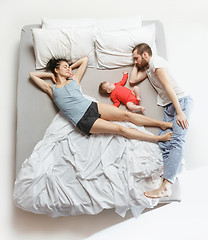 Image showing Top view of happy family with one newborn child in bedroom.