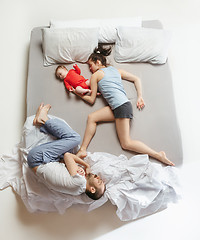 Image showing Top view of happy family with one newborn child in bedroom.