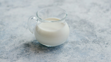Image showing Small cream pitcher with milk
