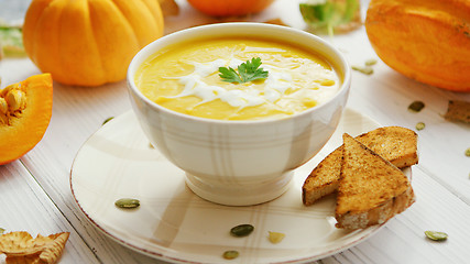 Image showing Pumpkin soup in bowl served with bread