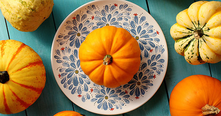 Image showing Pumpkins laid on plate and near